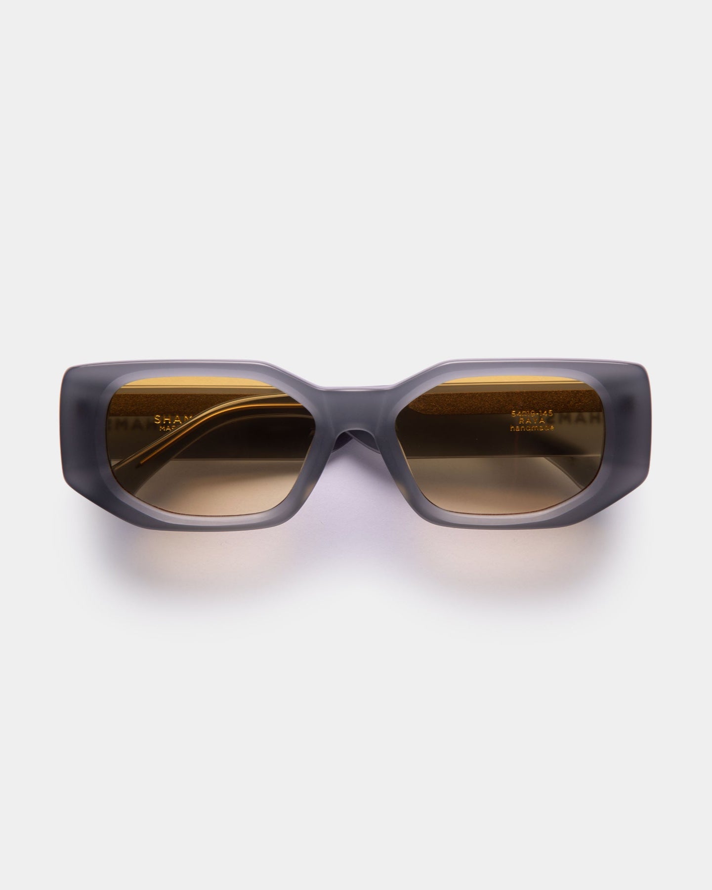 A pair of green RAYA sunglasses with a sleek design, displayed against a white background.