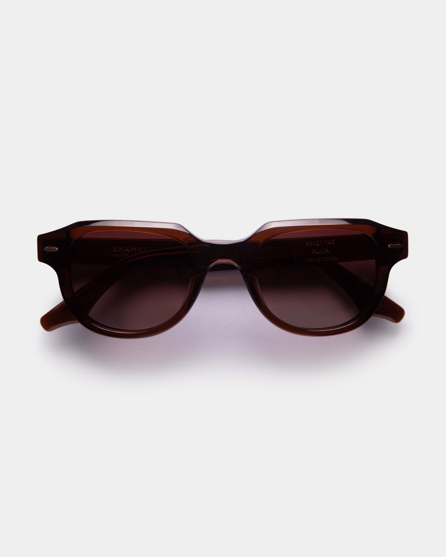 A pair of black ALMA sunglasses with a slightly rounded silhouette, displayed against a white background.