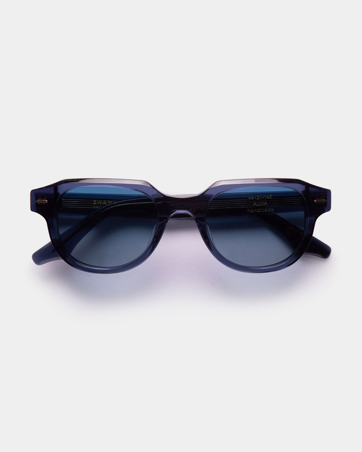 A pair of black ALMA sunglasses with a slightly rounded silhouette, displayed against a white background.