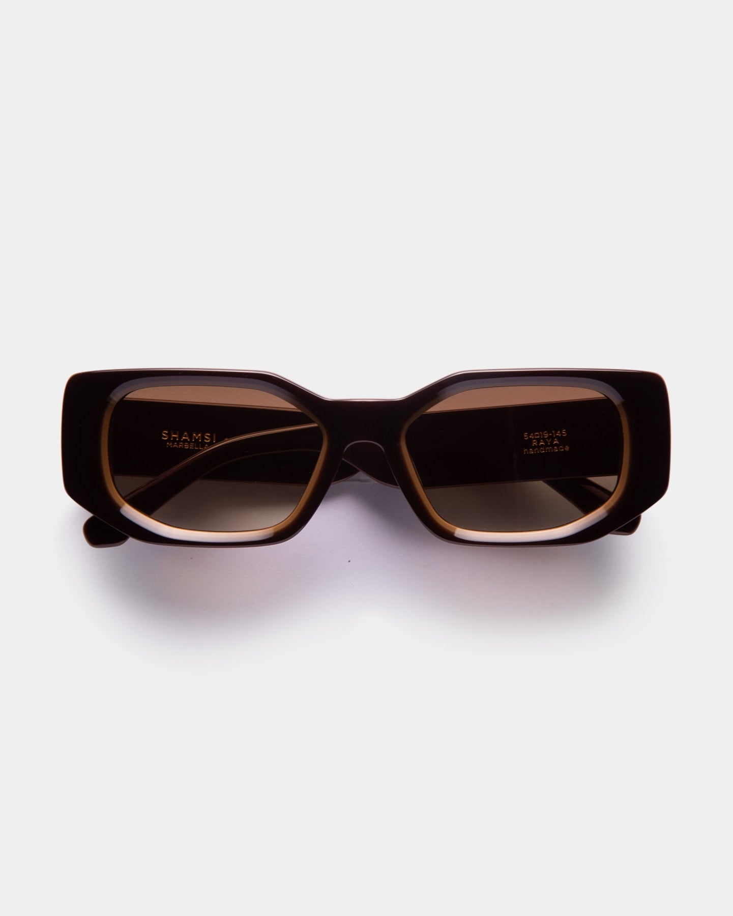 A pair of brown RAYA sunglasses with a sleek design, displayed against a white background.