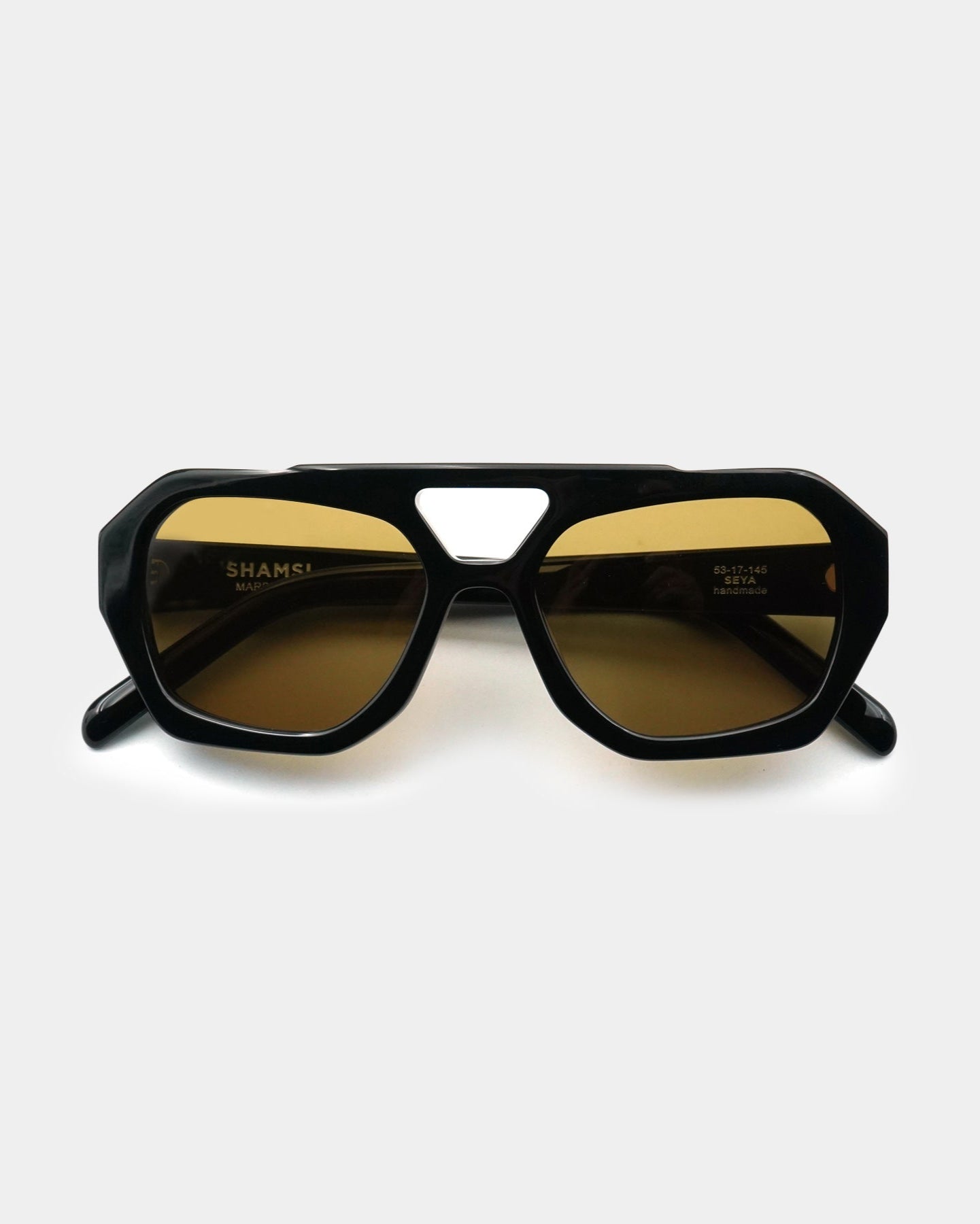 Black sunglasses with gold lenses on a white background