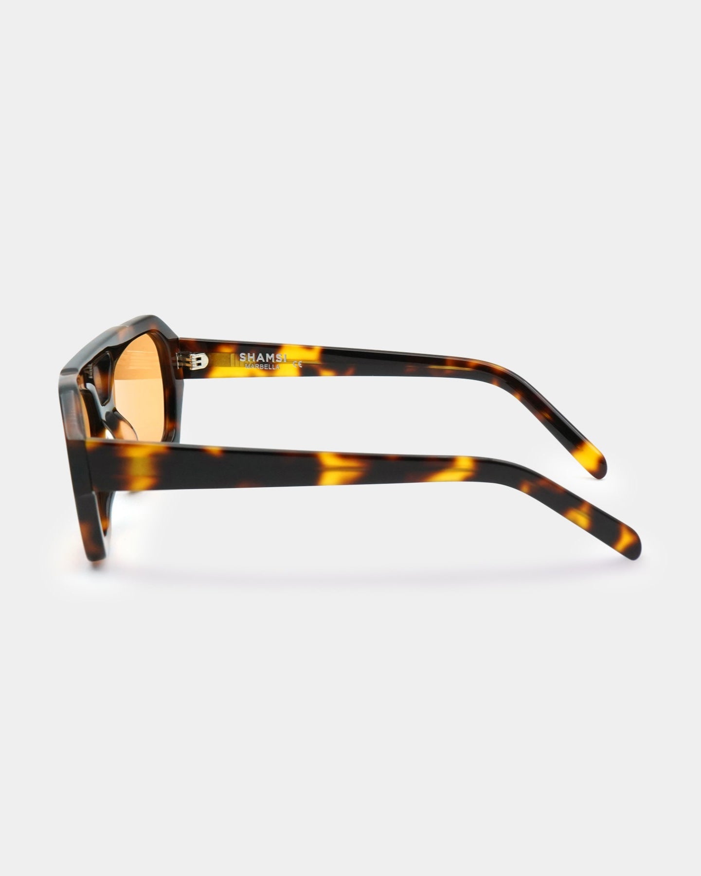 Sunglasses with tortoiseshell frame and orange lenses on a white background