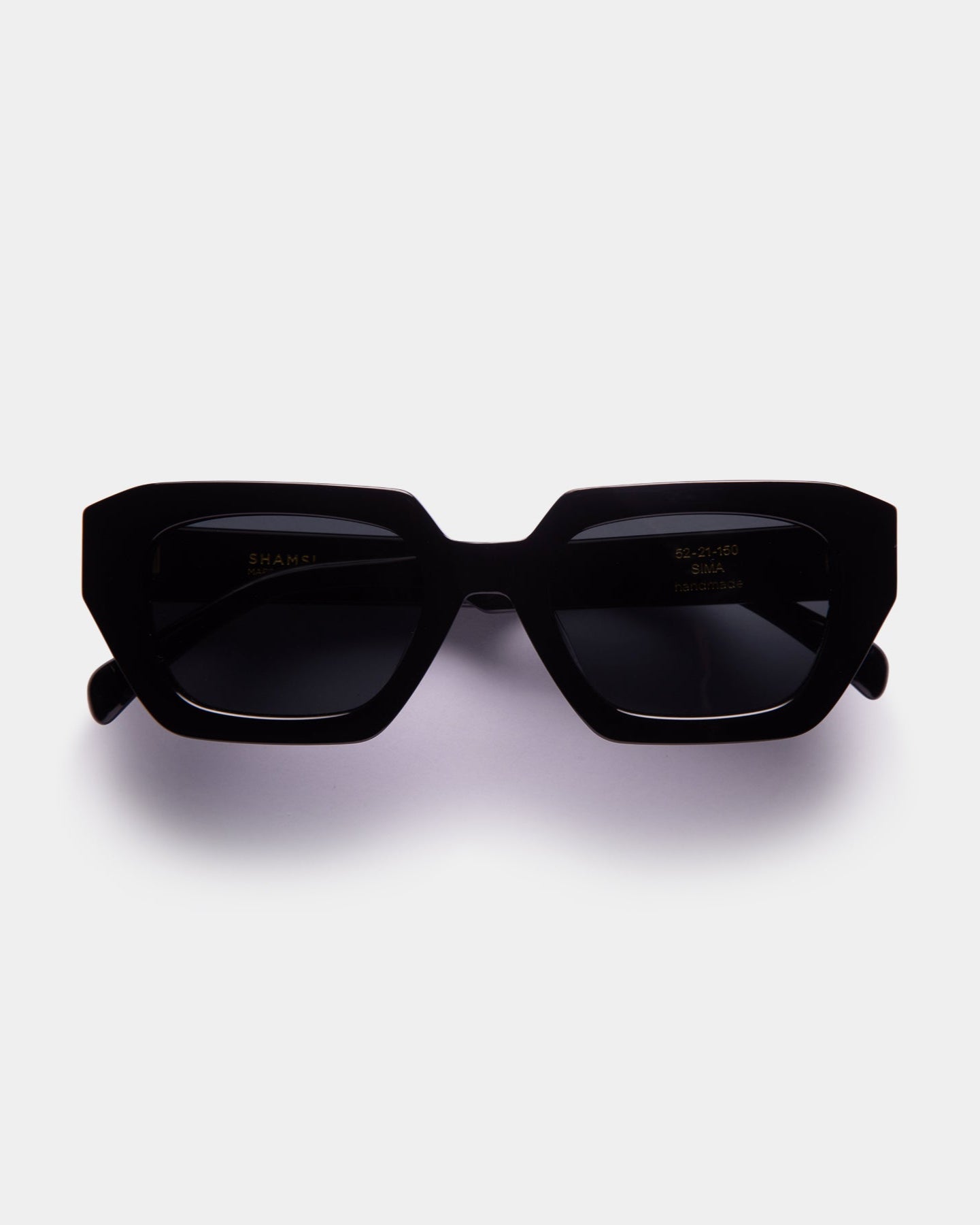 A pair of black, square-shaped sunglasses with a bold design, displayed against a white background.