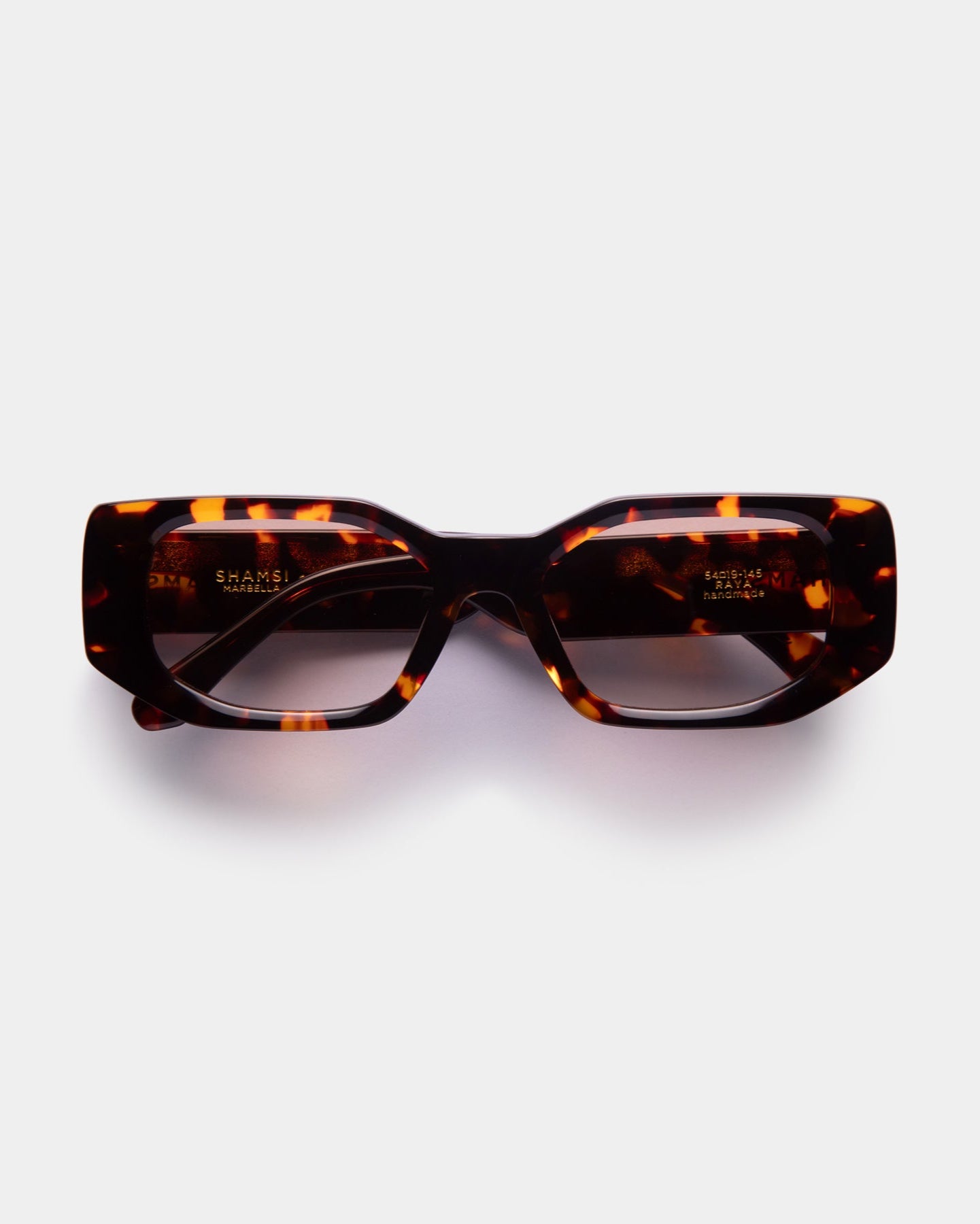 A pair of green RAYA sunglasses with a sleek design, displayed against a white background.