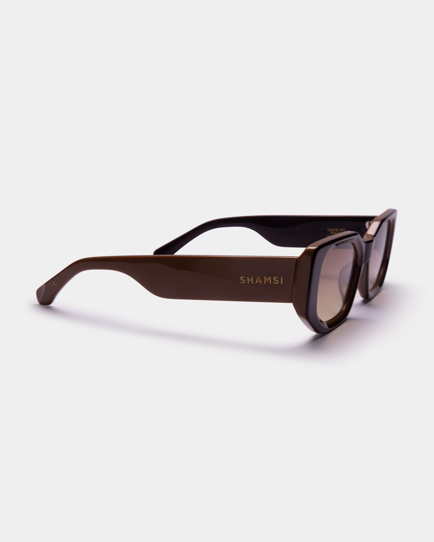 Brown sunglasses with 'SHAMSI' branding on a white background