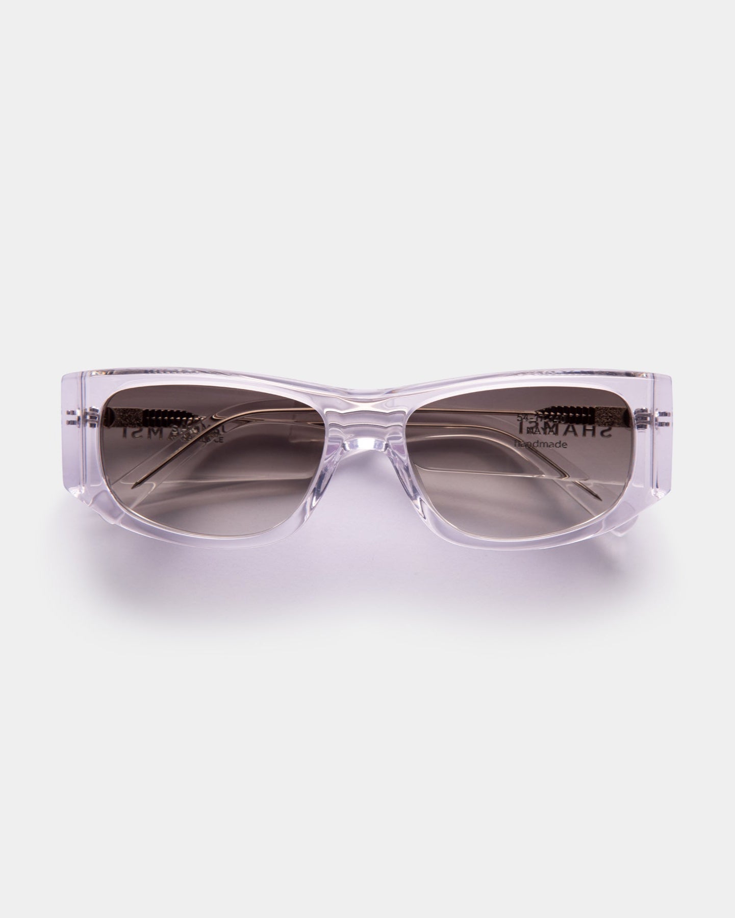 Clear sunglasses with dark lenses on a white background
