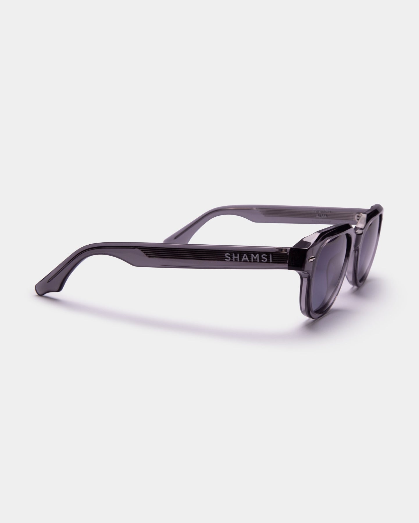 Sunglasses with 'SHAMSI' branding on a white background