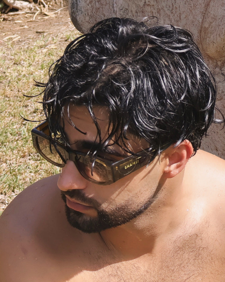 Man with wet hair and sunglasses outdoors