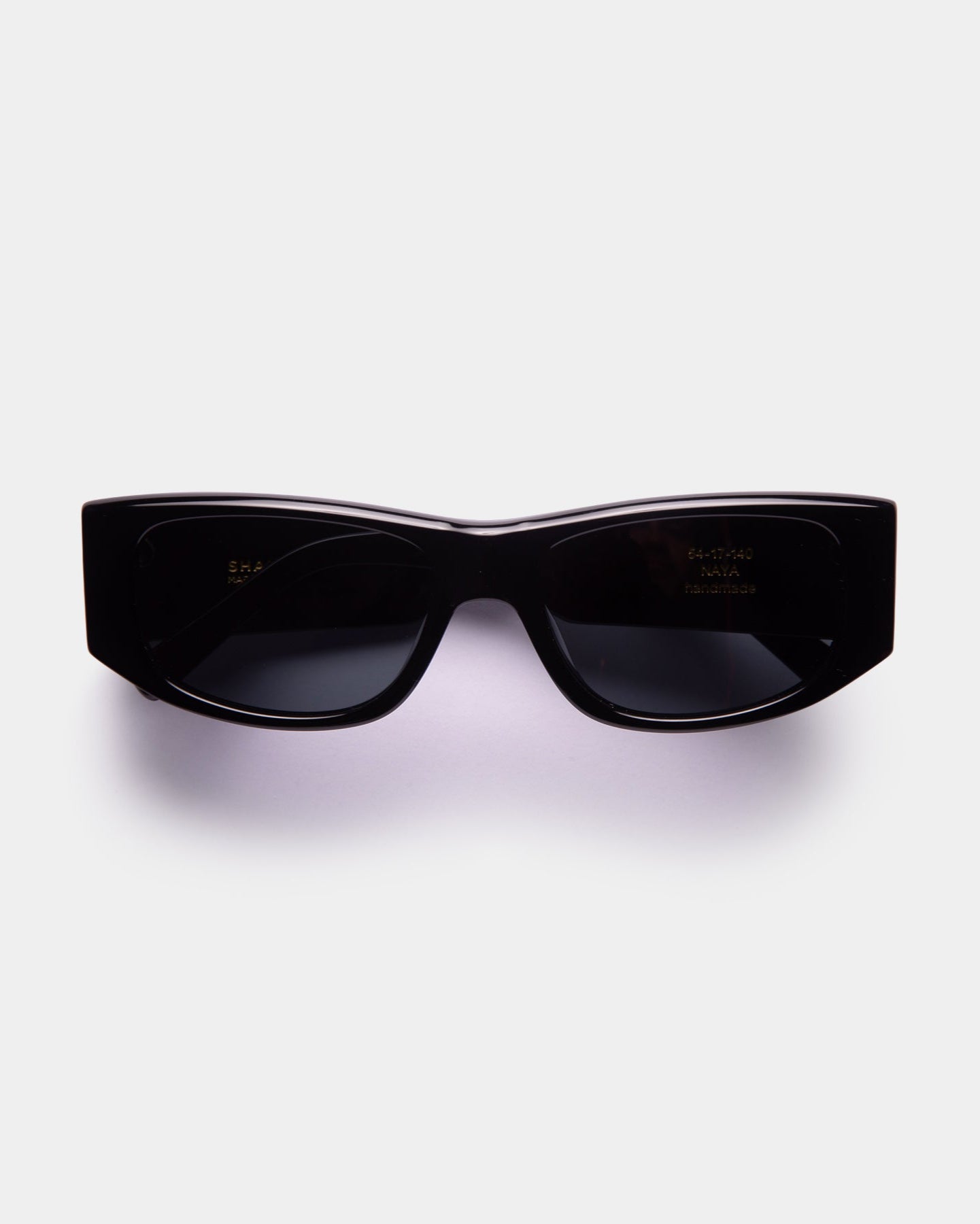 A pair of black unisex sunglasses with a sleek design, displayed against a white background.