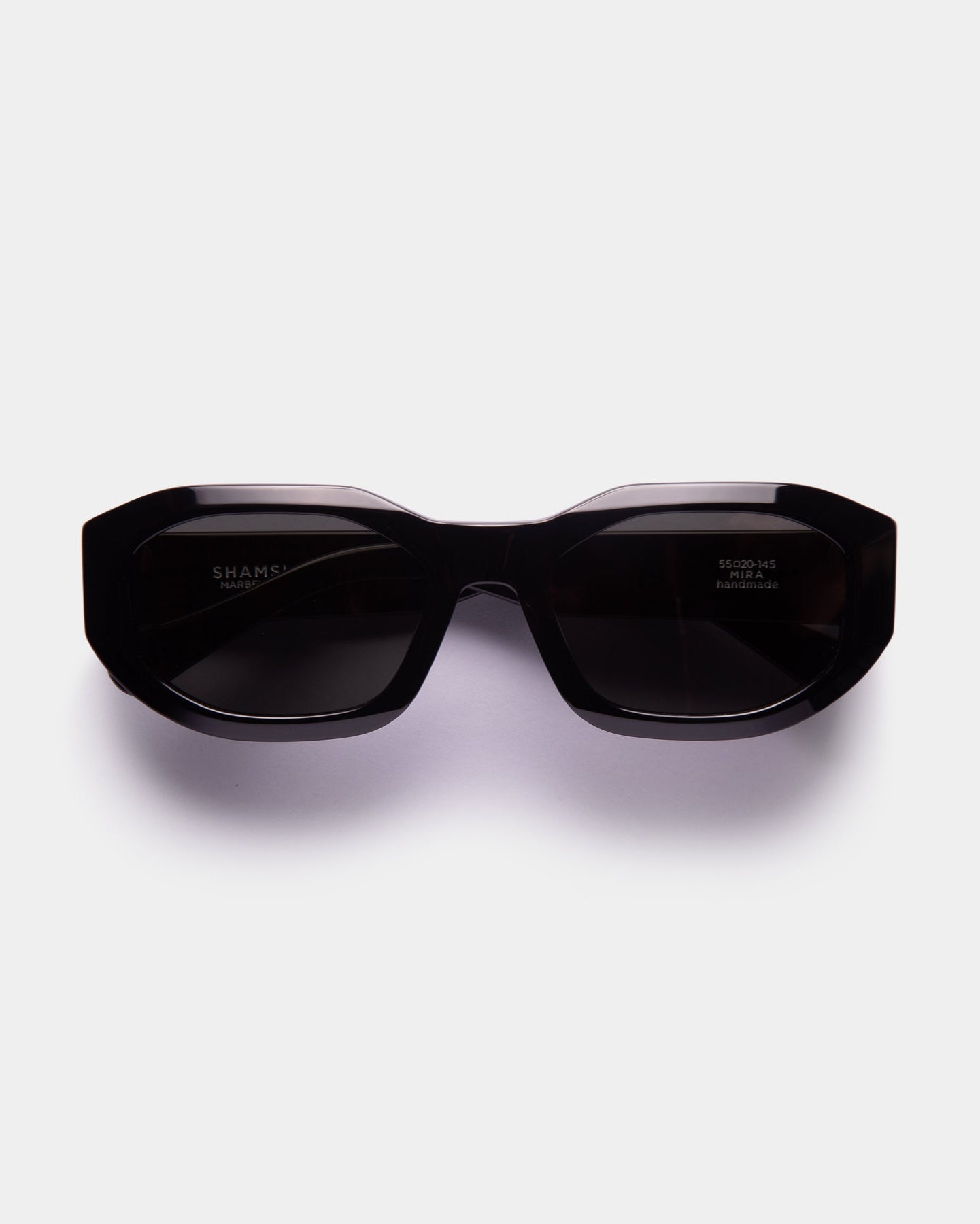 A pair of black, oversized sunglasses with a bold, fashionable design.