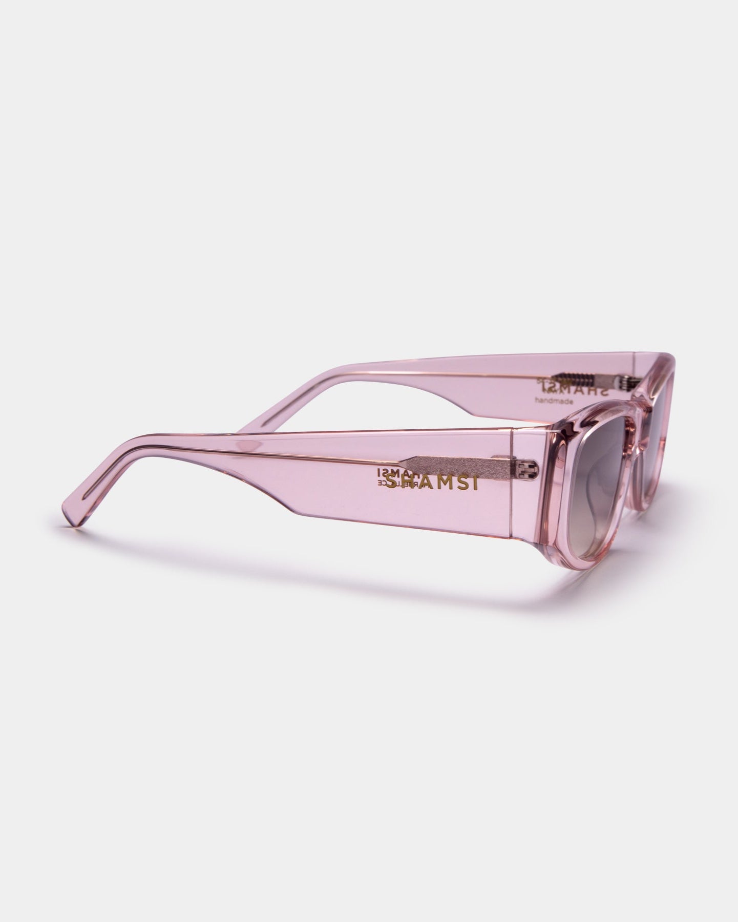 Pink sunglasses with a brand logo on a white background